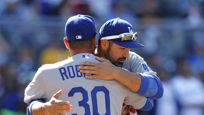 Adrian Gonzalez hugs Dave Roberts